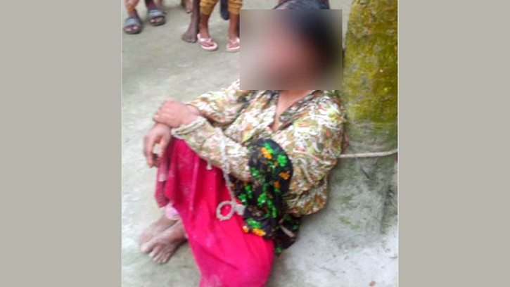 নারীকে গাছে বেঁধে চুল কেটে-জুতার মালা পরিয়ে নির্যাতন